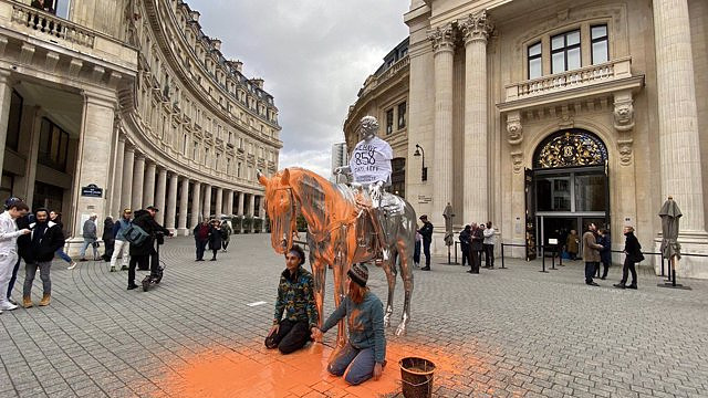 Environmental activists throw paint at a sculpture by American Charles Ray in Paris