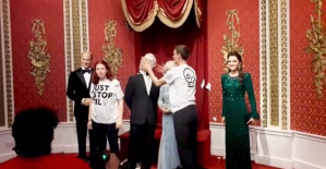 Climate activists throw a cake at the wax figure of King Charles III in London